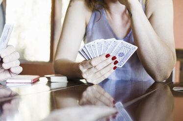 Cropped shot of young woman playing cards - CUF32226
