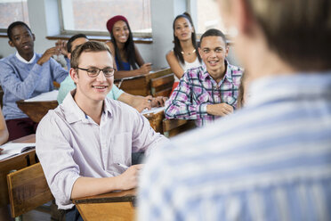 Students in classroom, listening to teacher - CUF32262