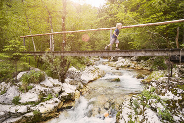 Boy running on wooden footbridge, Bovec, Soca, Slovenia - ISF09994