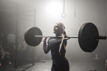 Young woman lifting barbell - ISF10119
