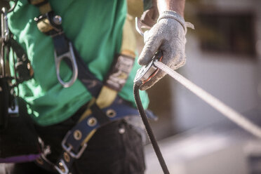 Close up of solar panel installation crew member with harness - ISF10222