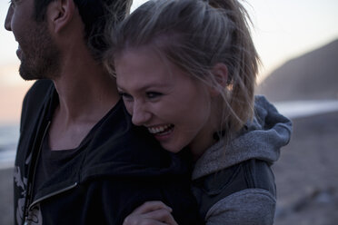 Couple hugging on beach, Malibu, California, USA - ISF10279