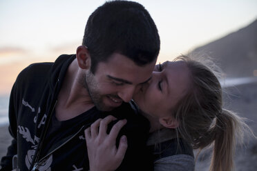 Couple hugging on beach, Malibu, California, USA - ISF10280