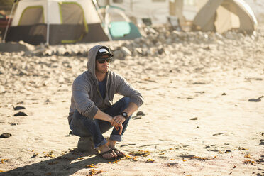 Man at beach camp, Malibu, California, USA - ISF10287