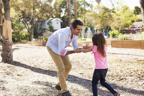 Mädchen und Vater spielen im Gemeinschaftsgarten - ISF10320