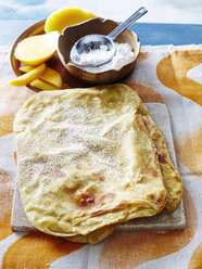 High angle view of somali sabaayah flatbread and mango slices - ISF10419