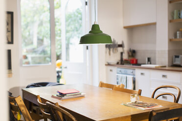 Green pendant light hanging over dining table - CAIF20700