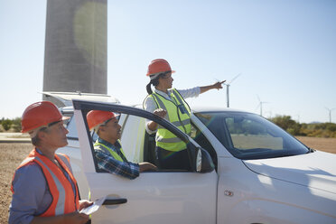 Ingenieure am Lkw in einem sonnigen Windkraftwerk - CAIF20791