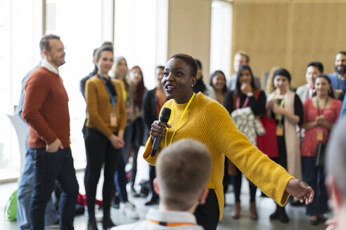 Audience listening to female speaker with microphone - CAIF20816