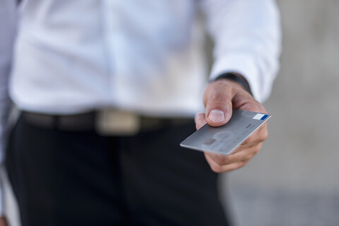 Close-up of businessman holding credit card stock photo