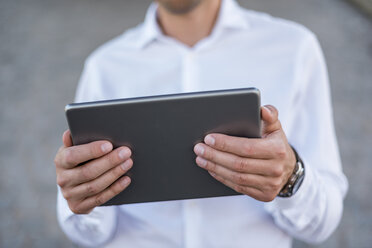 Close-up of businessman holding tablet - DIGF04707