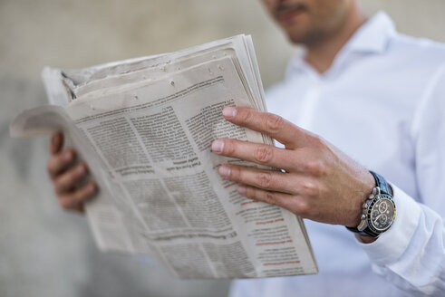 Close-up of businessman reading newspaper - DIGF04708