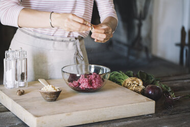 Preparation of beetroot ravioli with sage and butter, grating nutmeg - ALBF00483