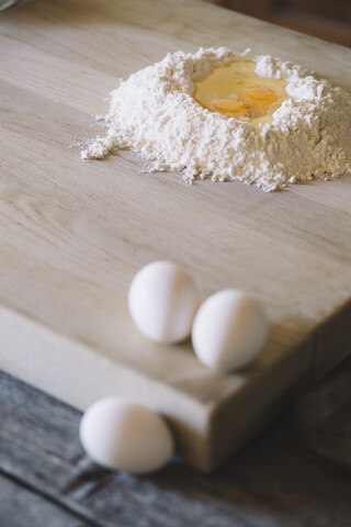 Wheat flower and semolina with egg yolk on pastry board stock photo