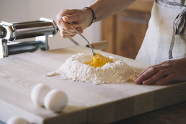 Woman preparing pasta dough, flour and eggs - ALBF00490