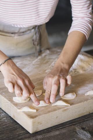 Woman preparing ravioli on pastry board stock photo