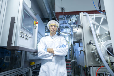 Portrait of male scientist with arms folded in lab cleanroom - CUF32679