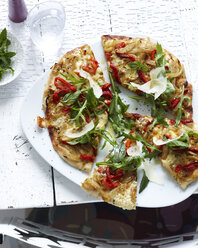 Plate of sliced wholemeal pizza with herbs, vegetable and parmesan - CUF32763