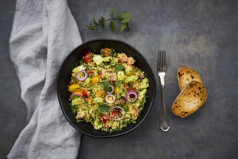 Tabbouleh made of couscous, tomatoes, red onions, cucumber, parsley and mint stock photo