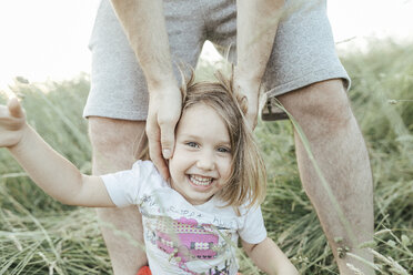 Portrait of happy little girl with father in nature - KMKF00374