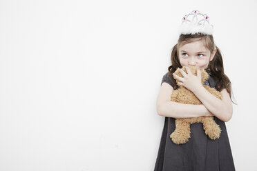 Girl wearing tiara holding teddy bear - ISF10532