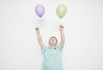 Boy holding balloons - ISF10537