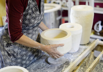 Close-up of woman working in porcelain workshop - BFRF01855