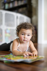 Little girl reading board book - ISF10802