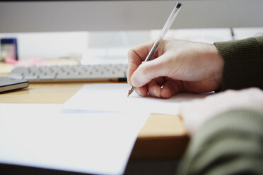 Man writing on paper with pen - ISF10818