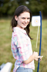 Portrait of teenage girl practicing archery - ISF10875