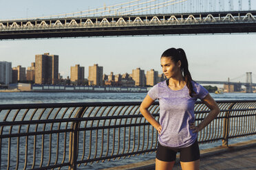 Young female runner looking out in front of Manhattan bridge, New York, USA - ISF11086