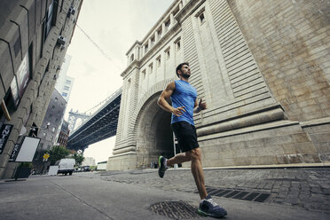 Young male runner running in Brooklyn, New York, USA - ISF11105