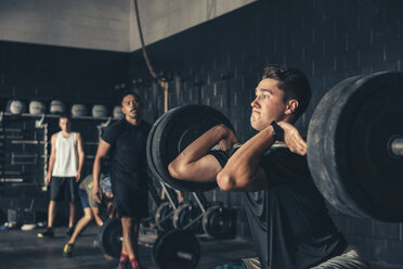 Man and trainer training with barbell in gym - ISF11148