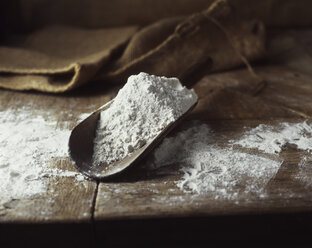 Organic bakery ingredients, scoop of white flour on table - ISF11169