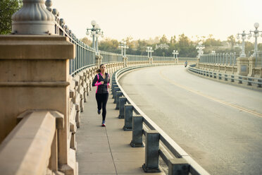 Jogger running on bridge, Arroyo Seco Park, Pasadena, California, USA - ISF11319