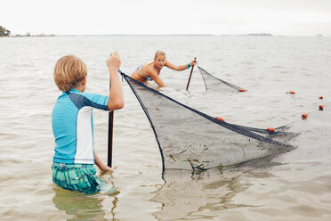 Kids in water using fishing net, Sanibel Island, Pine Island Sound