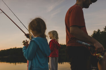 Father and daughters fishing, Kings Lake, Ontario, Canada - ISF11588