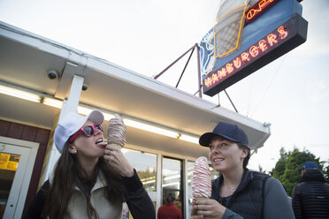 Hikers enjoying ice cream cone at cafe, Lake Blanco, Washington, USA - ISF11646