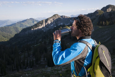 Hiker taking break, drinking, Sunset Peak trail, Catherine's Pass, Wasatch Mountains, Utah, USA - ISF12009