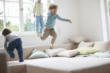 Three young boys jumping on sofa - ISF12055