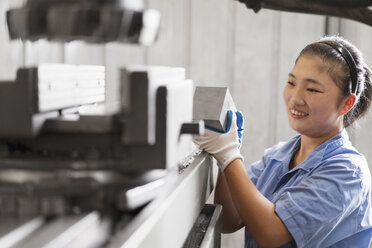 Female factory worker in crane factory, China - ISF12089