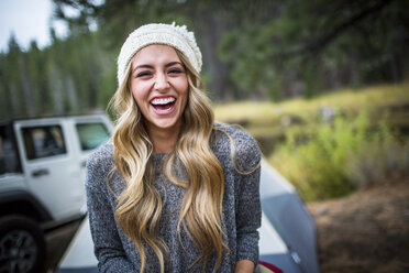 Portrait of young woman wearing knit hat at campsite, Lake Tahoe, Nevada, USA - ISF12272