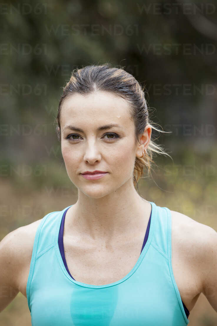 Portrait of young attractive woman wearing tank top and shorts