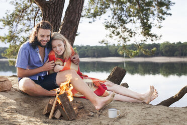 Young couple camping by lake - ISF12618