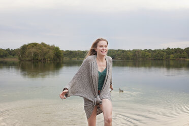 Young woman playing in lake - ISF12624