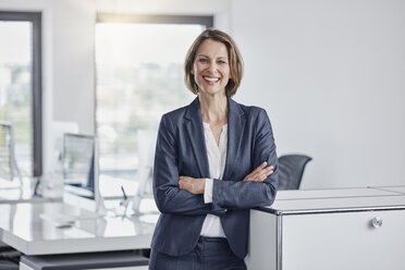 Portrait of happy businesswoman in office - RORF01354