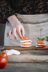 Woman's hands preparing Caprese Salad - ALBF00525