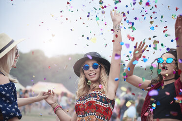 Friends dancing among confetti at the music festival - ABIF00602