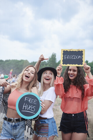 Happy women at the music festival with signs, free hugs, freedom stock photo