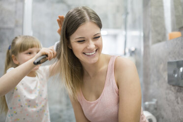 Kleines Mädchen bürstet die Haare ihrer Mutter - AWF00075